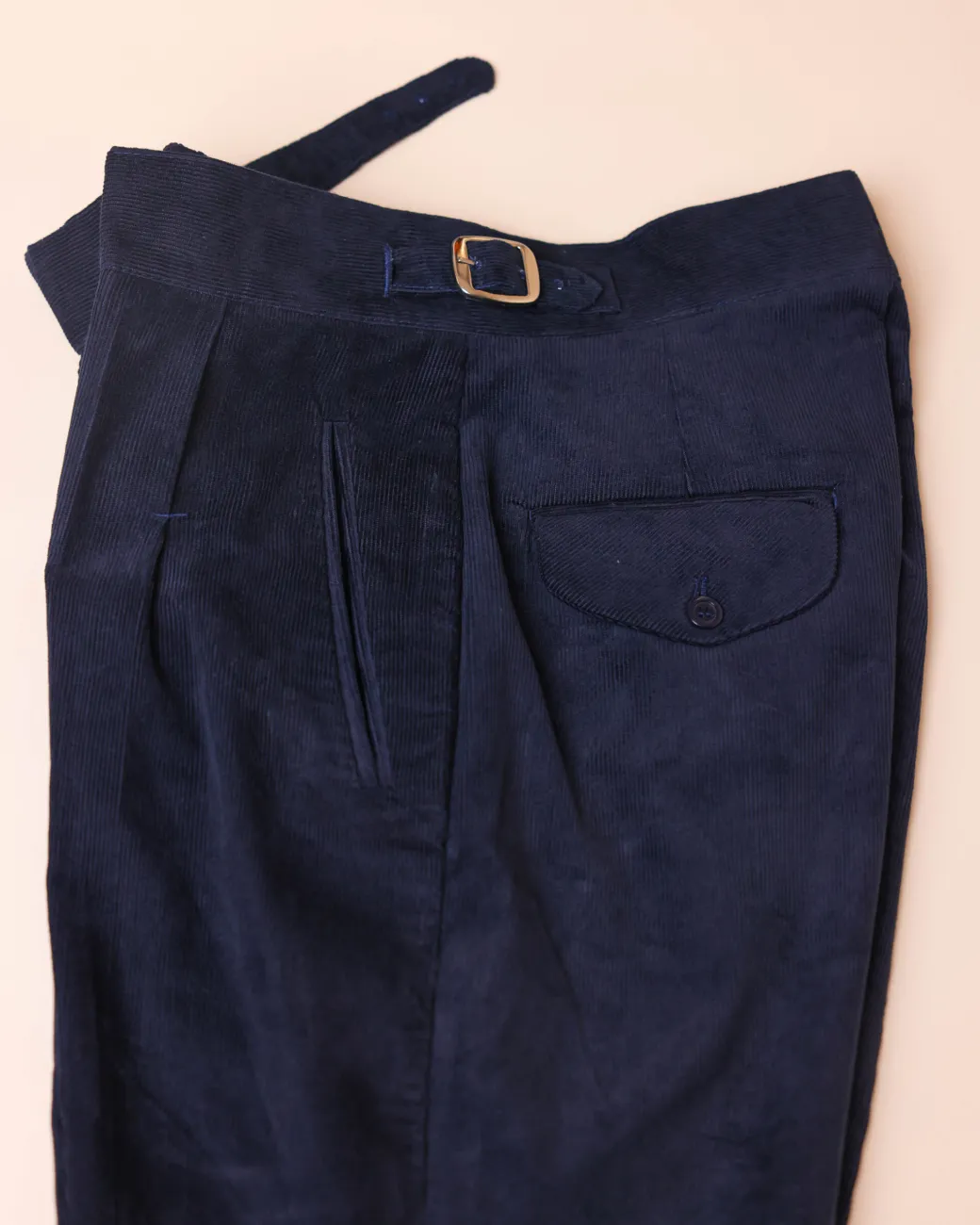 Gurkha trousers with pleats, double side strap buckles, slanted front welt pockets, and a back patch pocket.