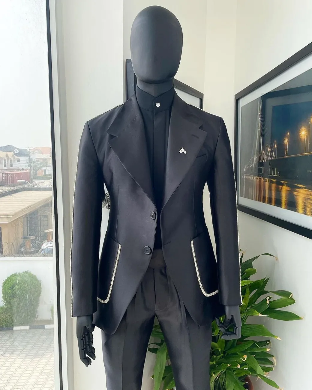 The Monochrome “okorodudu” mikado satin, charcoal black, big-notch lapel suit.