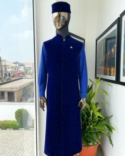 The “orunmila” navy blue Trench soaked Italian velvet traditional jacket with black Swarovski stones detailing, matching hat, cobalt blue Senator kaftan & pant trousers.