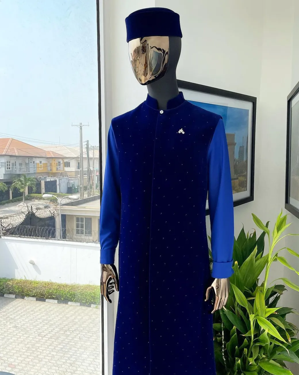 The “orunmila” navy blue Trench soaked Italian velvet traditional jacket with black Swarovski stones detailing, matching hat, cobalt blue Senator kaftan & pant trousers.