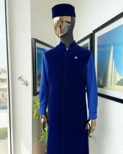 The “orunmila” navy blue Trench soaked Italian velvet traditional jacket with black Swarovski stones detailing, matching hat, cobalt blue Senator kaftan & pant trousers.