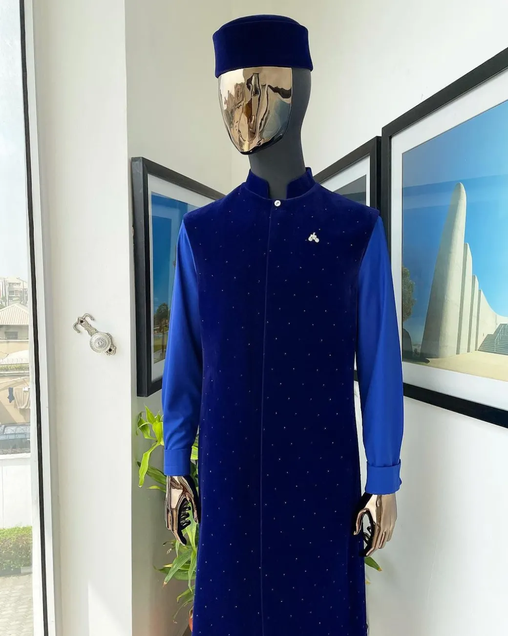 The “orunmila” navy blue Trench soaked Italian velvet traditional jacket with black Swarovski stones detailing, matching hat, cobalt blue Senator kaftan & pant trousers.