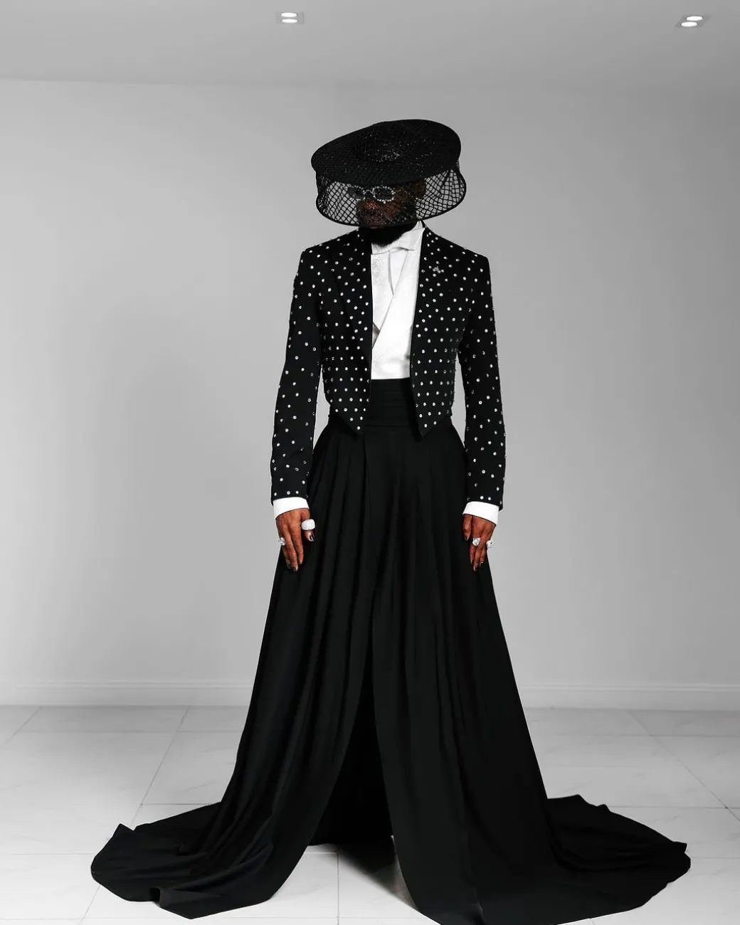 The ”Prince” Charcoal Black Short Peak Lapel Suit With ss30 Swarovski Stones, Double-breasted Waistcoat, High Pant Trousers & Pleated Long Tail Skirt.